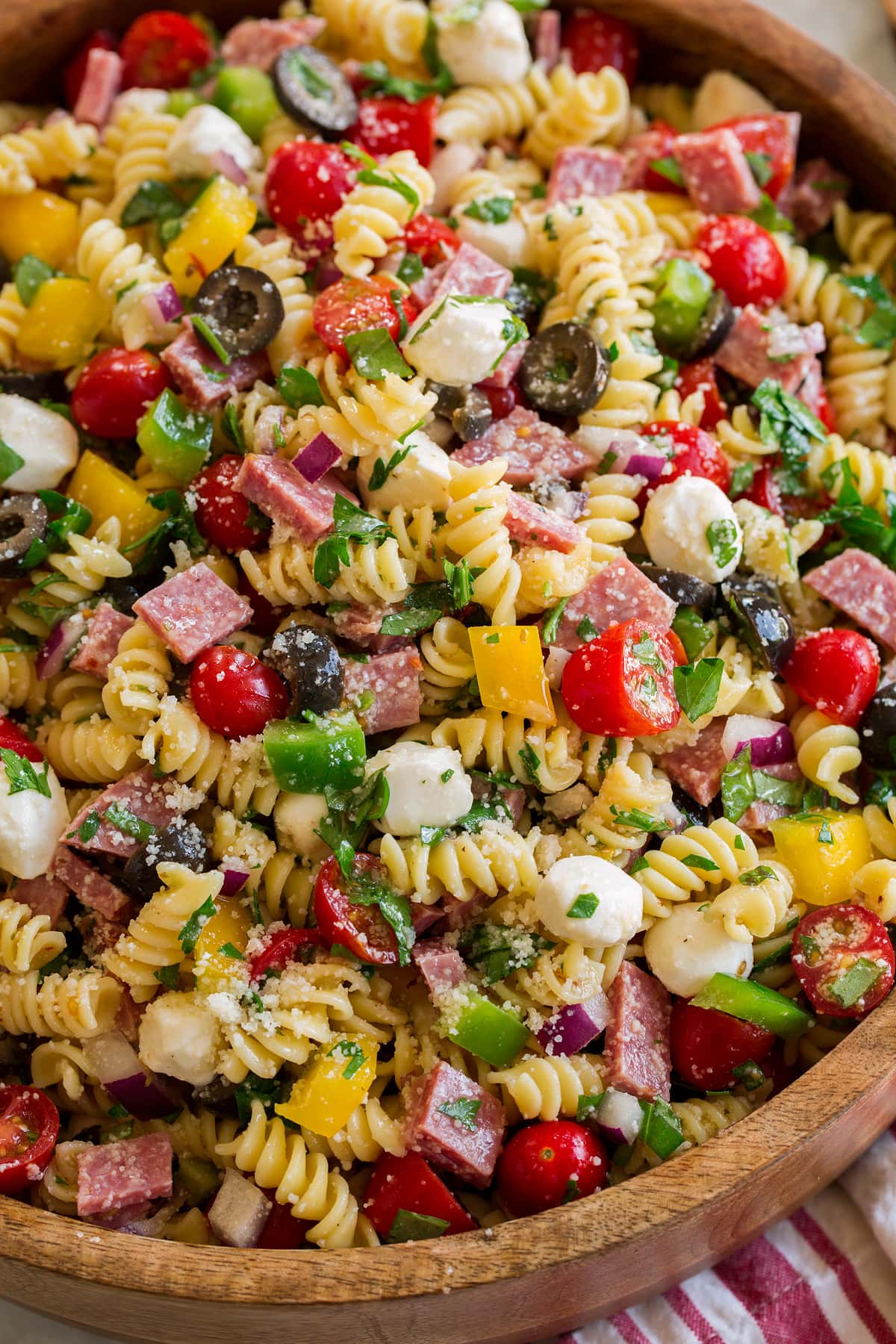 Close up photo of Italian pasta salad showing all the textures and fresh ingredients of the pasta salad.