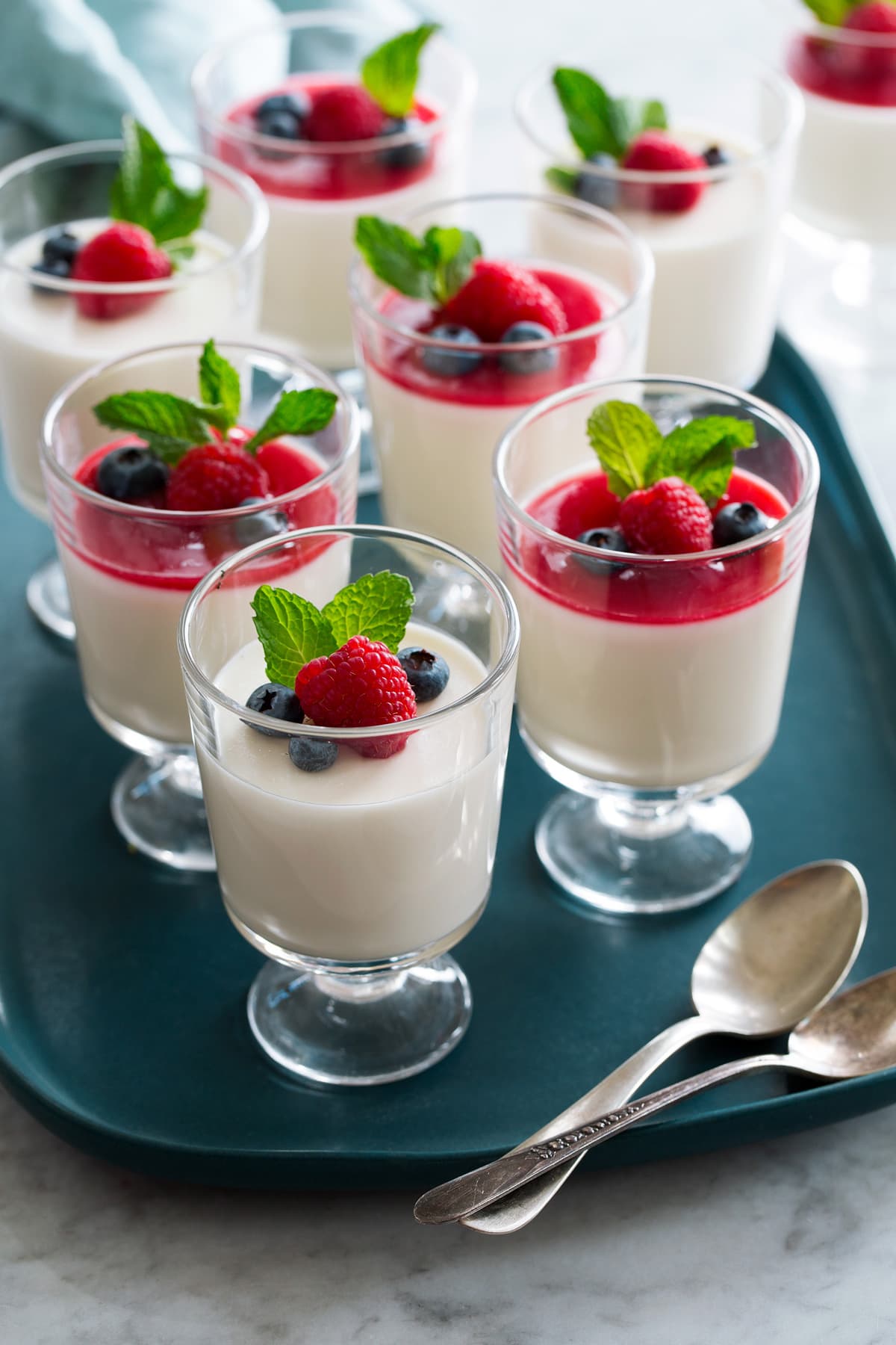 Photo: Eight servings of panna cotta shown in glass dessert cups.