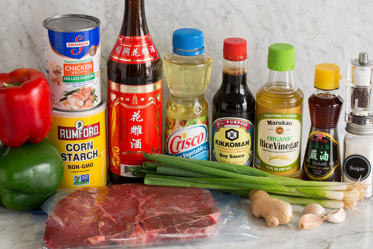 Photo: Ingredients used to make pepper steak shown here. Includes bell peppers, cornstarch, steak, Chinese vinegar, vegetable oil, soy sauce, rice vinegar, sesame oil, green onions, ginger, garlic, salt, pepper and sugar. 