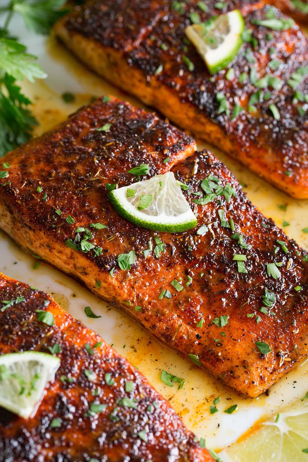 Close up photo of blackened salmon with buttery honey lime sauce.