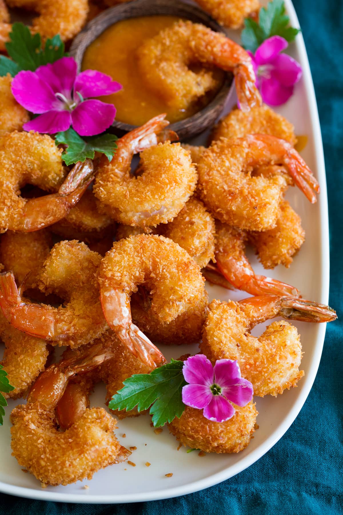 Photo: Coconut Shrimp shown close up from a side angle on a platter.