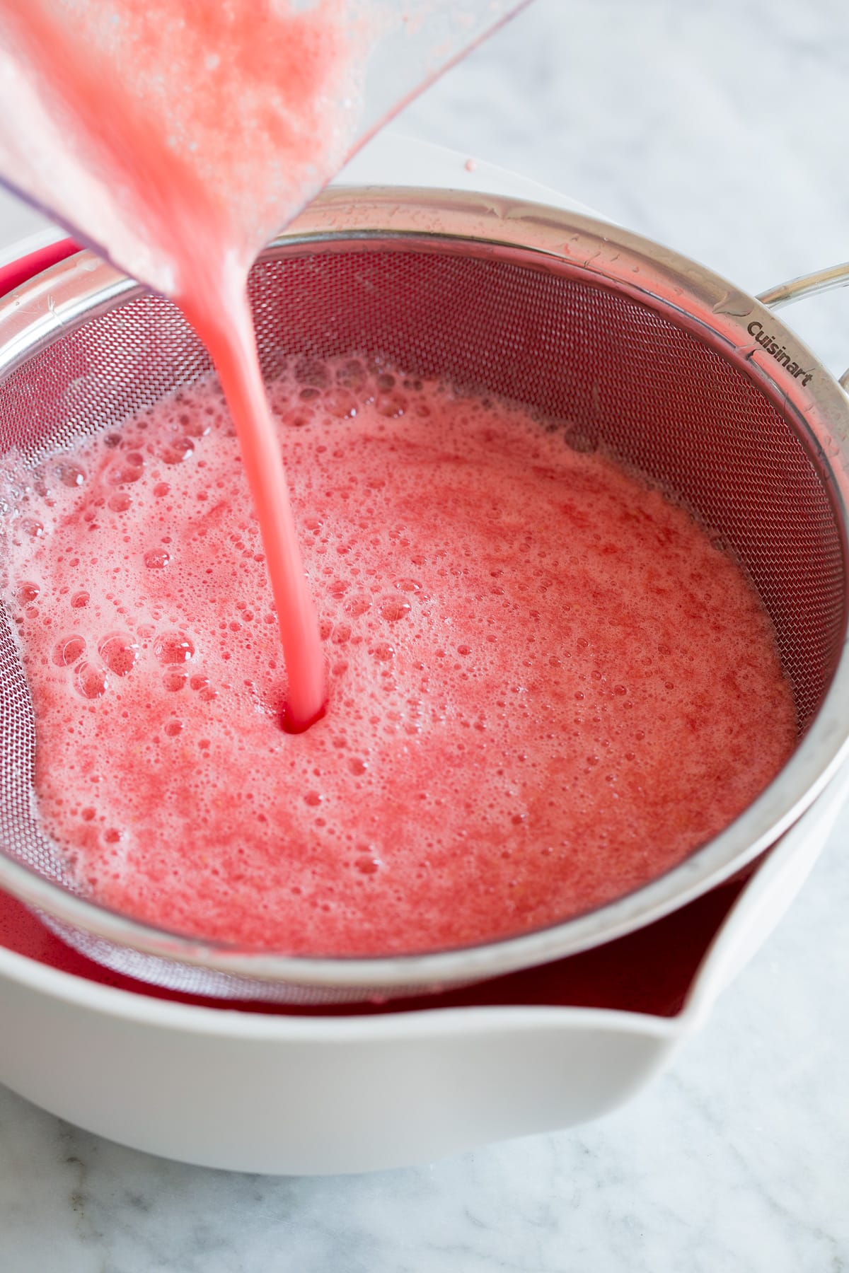 Photo: Watermelon aqua fresca being draing in a large bowl.