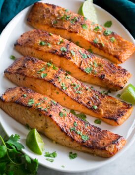 Broiled Salmon shown on a serving platter in a row of four.