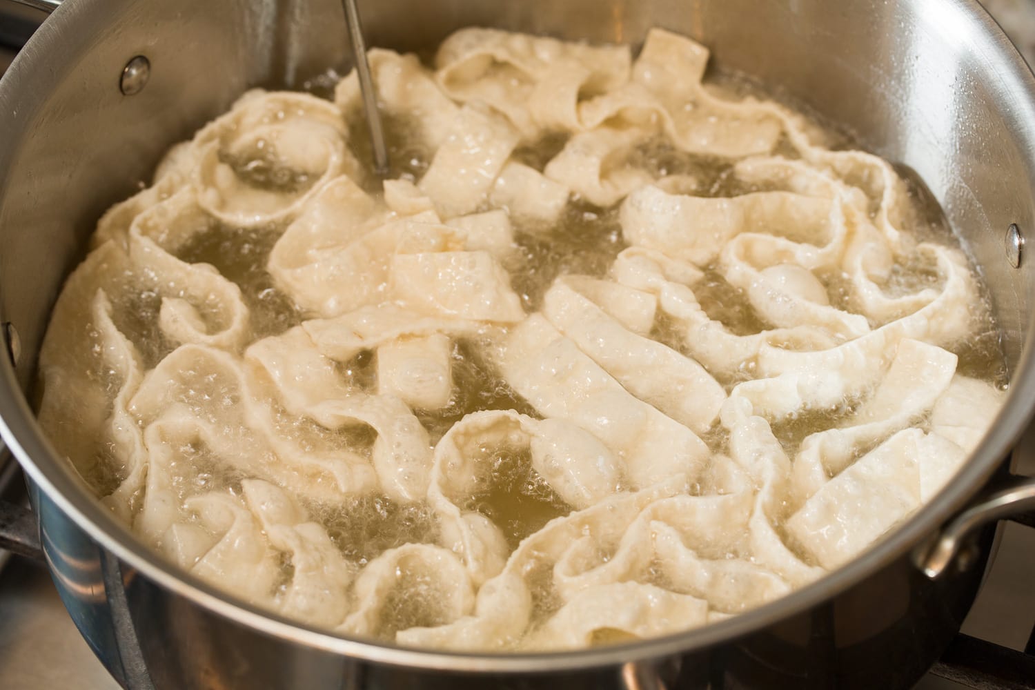 Deep frying wonton strips.