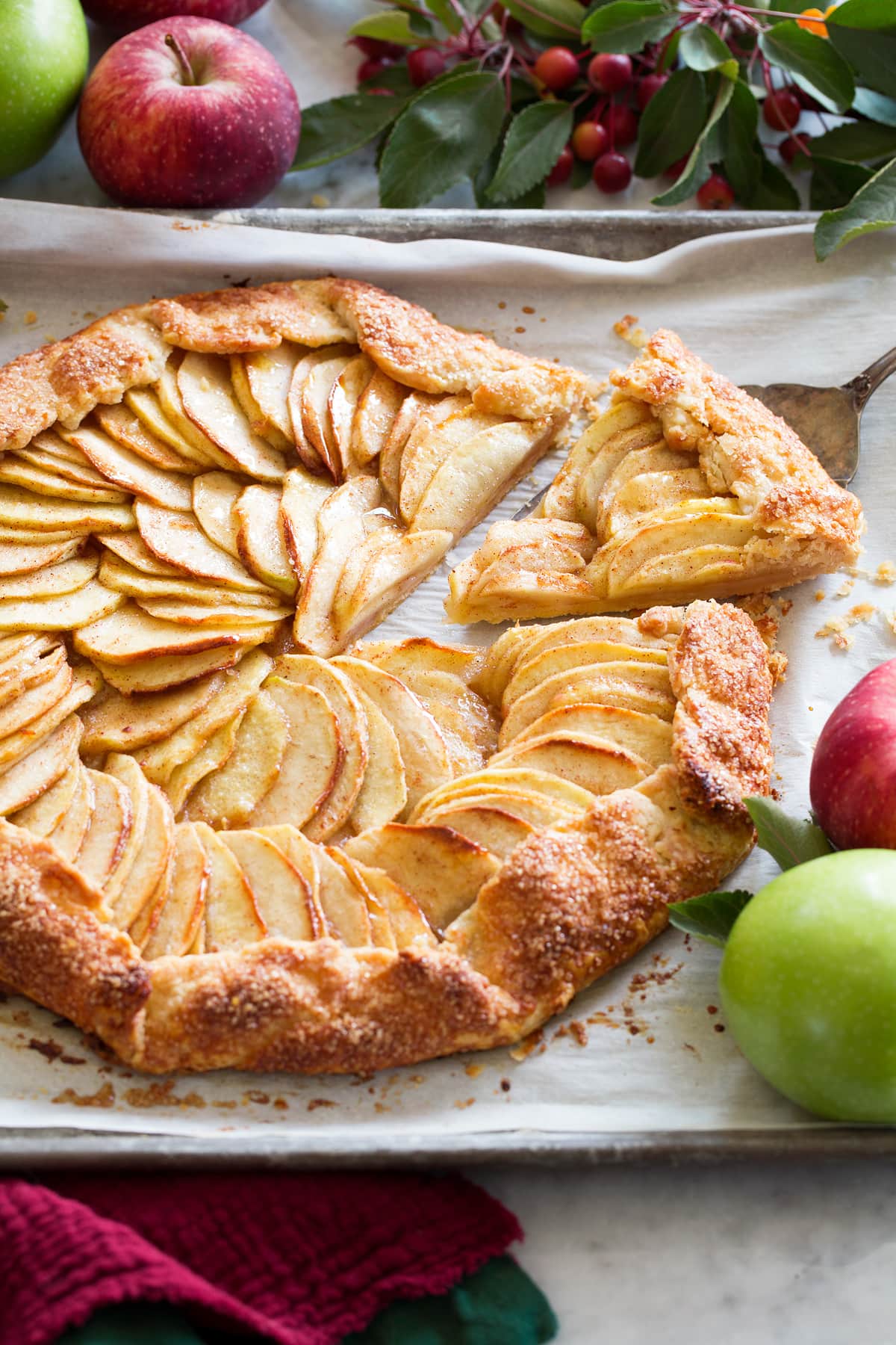 Apple galette with a slice being removed.