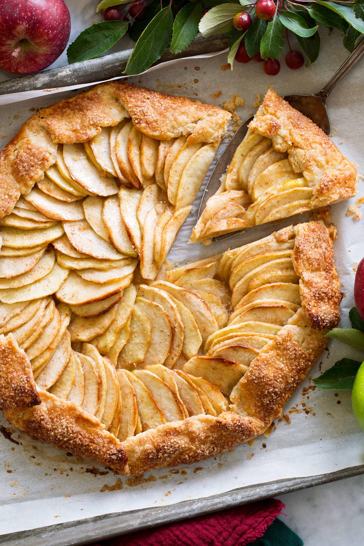 Overhead photo of apple galette with a slice being removed.