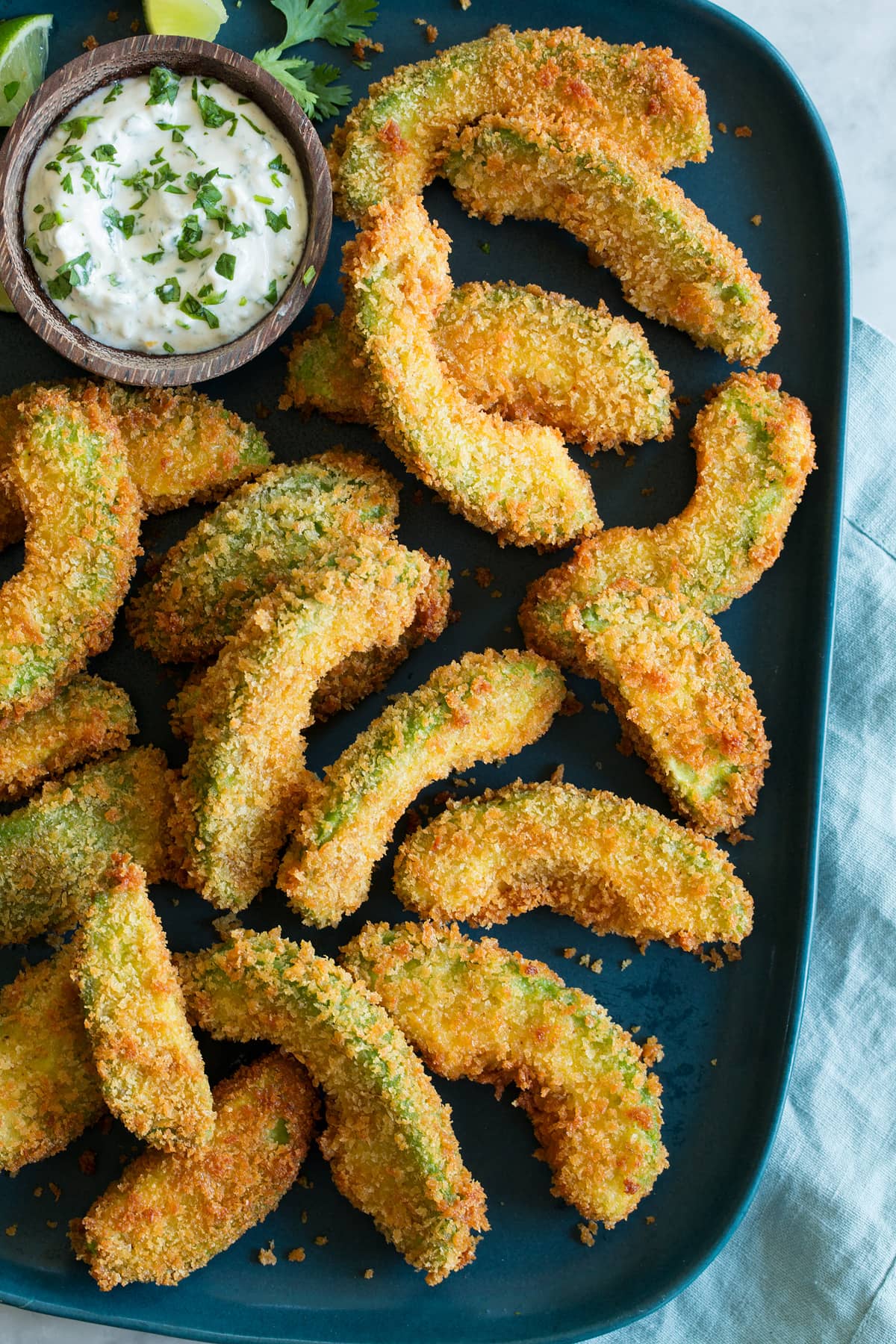 Close up photo of breaded fried avocado slices, shown overhead. 