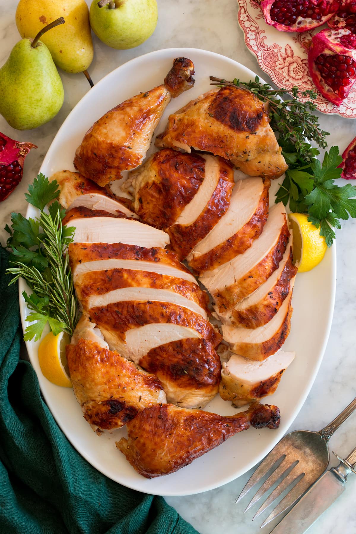 Carved roast chicken shown on an oval serving platter.