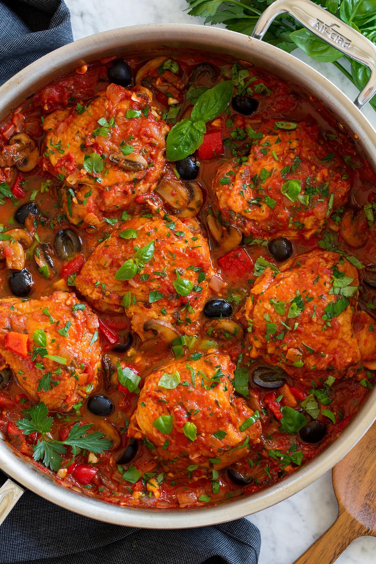 Overhead photo of chicken cacciatore shown in a stainless steel saute pan.