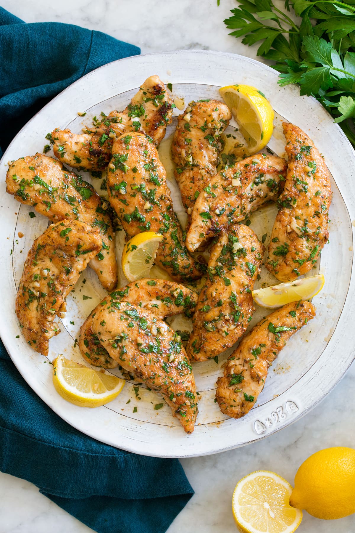 Plate full of pan fried chicken tenders.