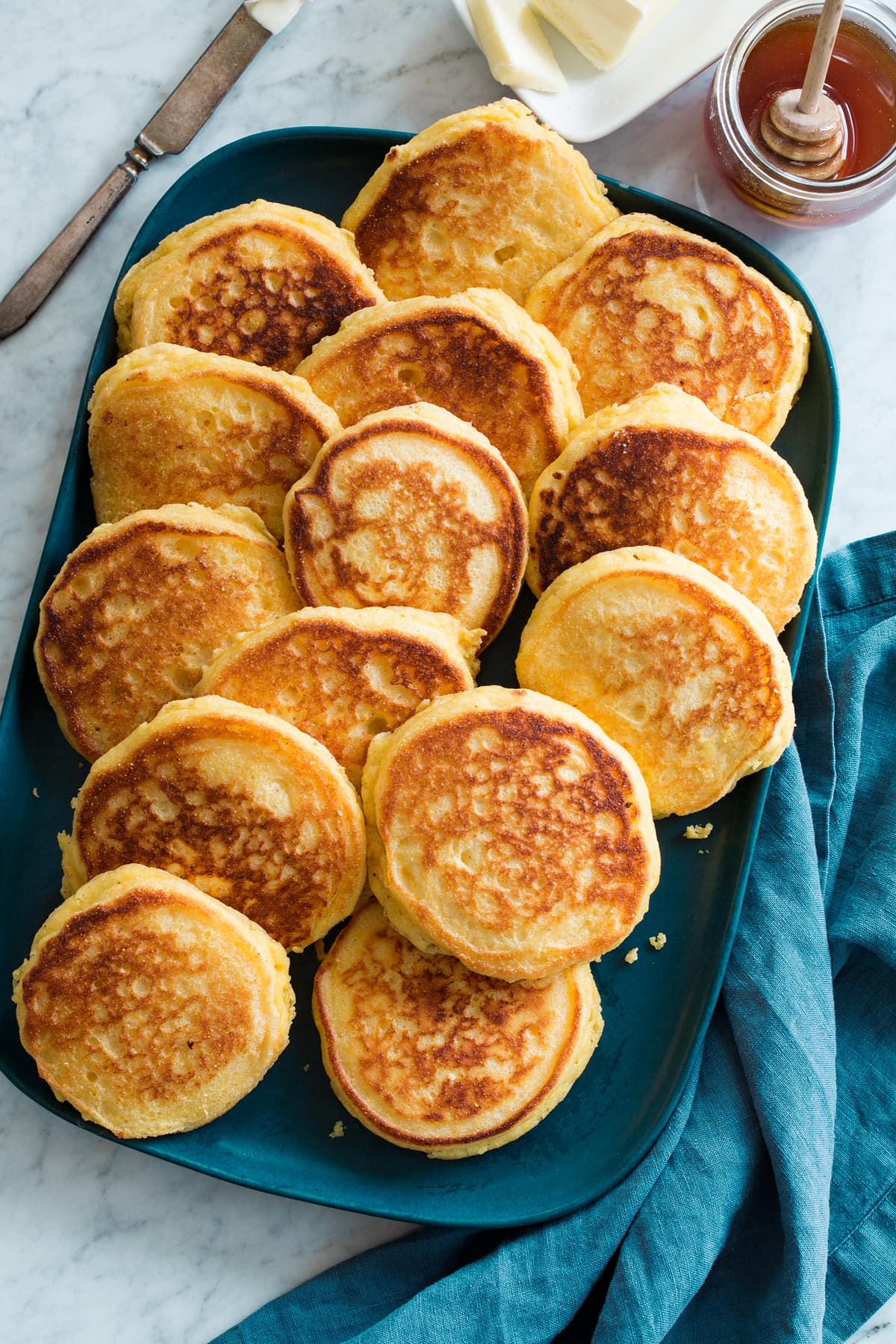 Overhead photo of blue platter full of stacked Southern hoecakes.