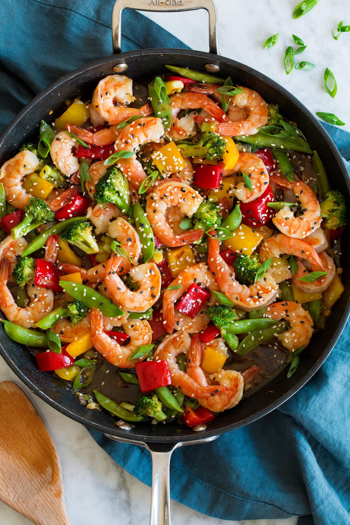 Shrimp stir fry shown in a dark skillet.