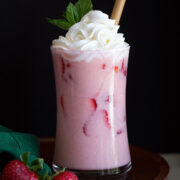 Pink drink with strawberry slices.