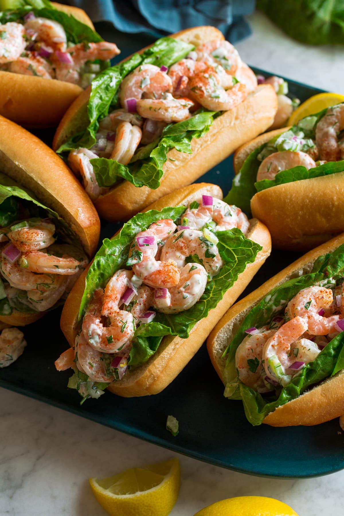 Shrimp salad in rolls with lettuce.