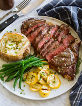 Grilled steak sliced and served with rosemary garlic butter.