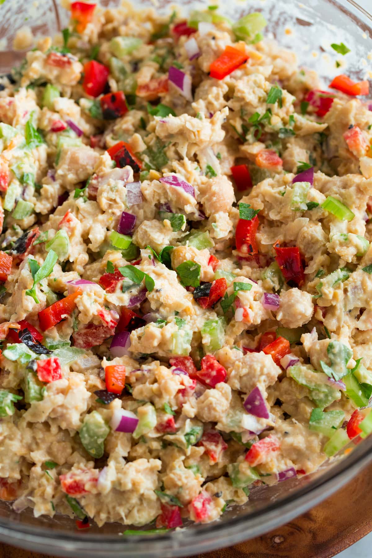 Chickpea salad in a glass mixing bowl.