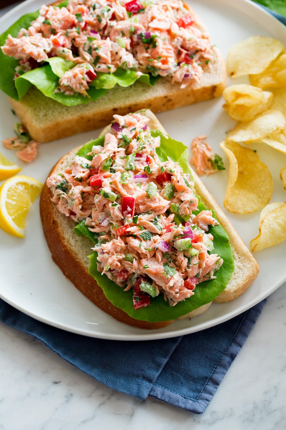 Salmon salad shown on a slice of bread.