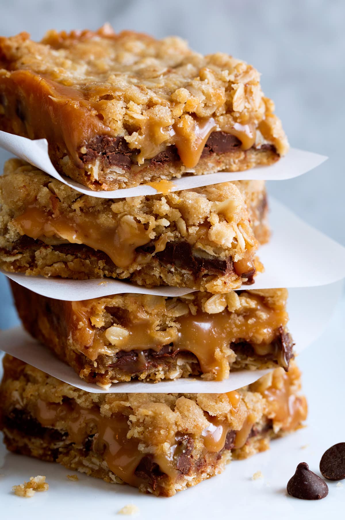 Close up photo of stack of caramel chocolate oatmeal cookie bars.