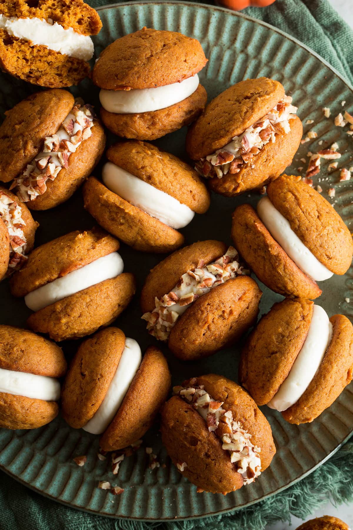 Close up photo of pumpkin whoopie pies with cream cheese frosting filling.