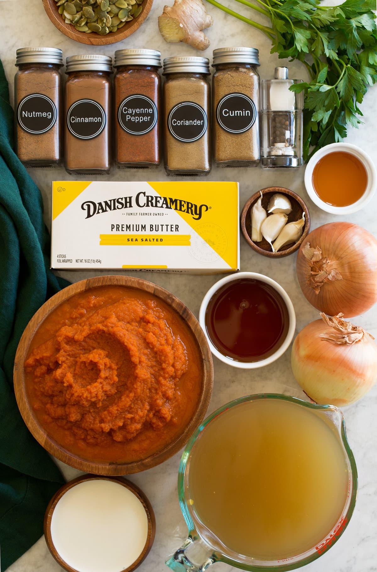 Ingredients needed to make homemade pumpkin soup shown.