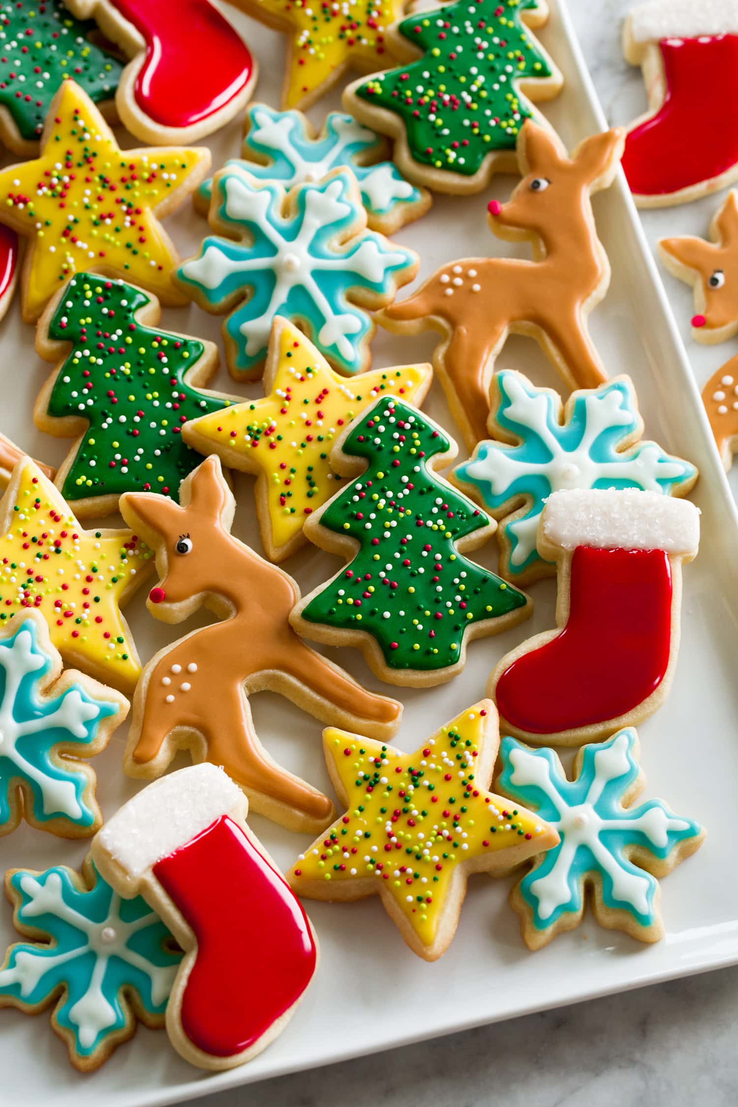 Iced sugar cookies on a rectangular white tray.