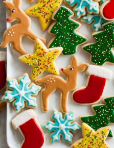 Sugar cookie icing shown over cookies in various colors and shapes.