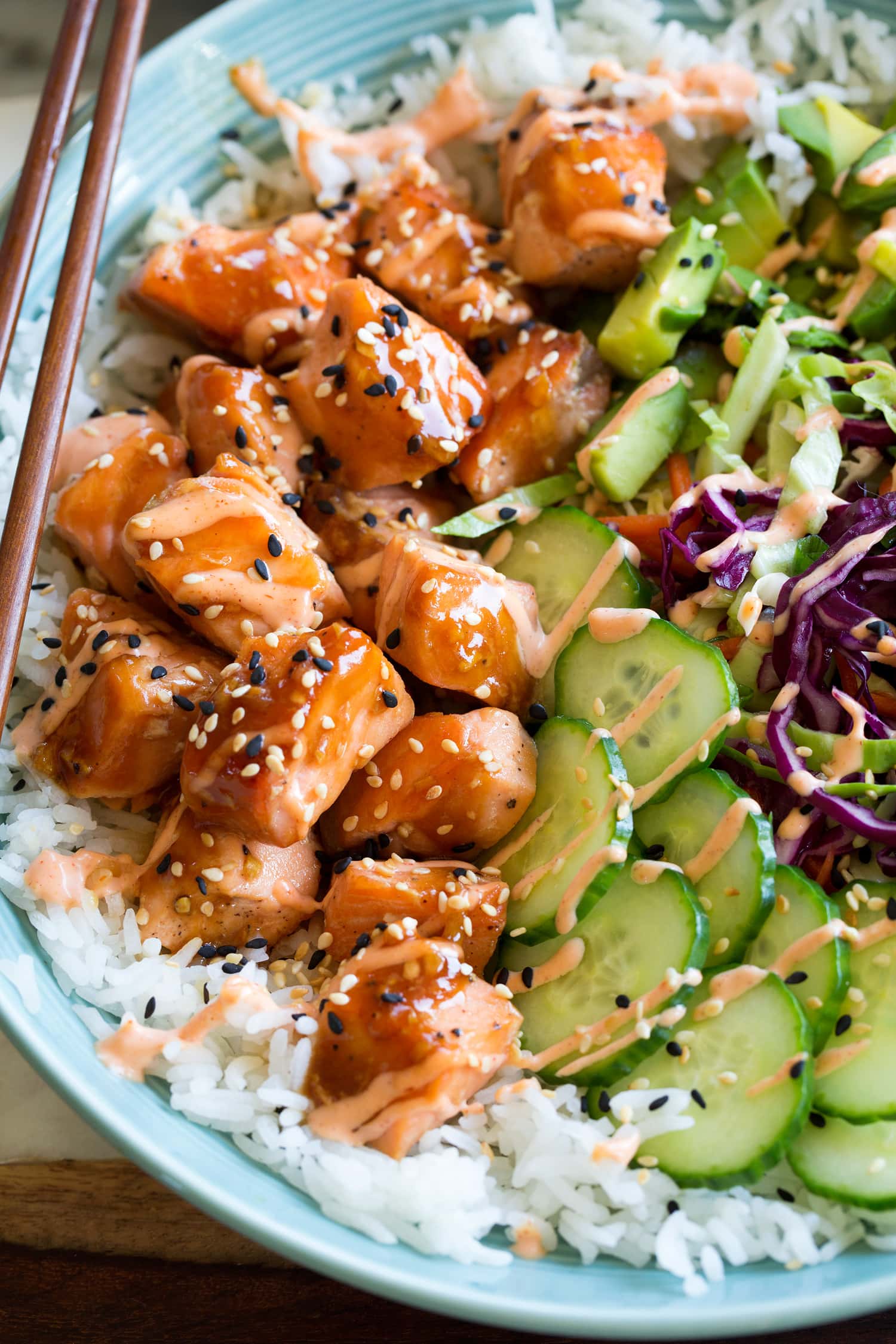 Close up photo of glazed salmon, veggies and white rice.