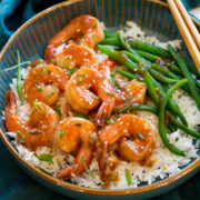 Teriyaki shrimp served with a side of steamed rice and green beans.