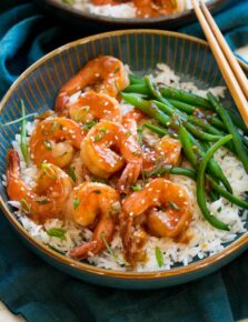 Teriyaki shrimp served with a side of steamed rice and green beans.