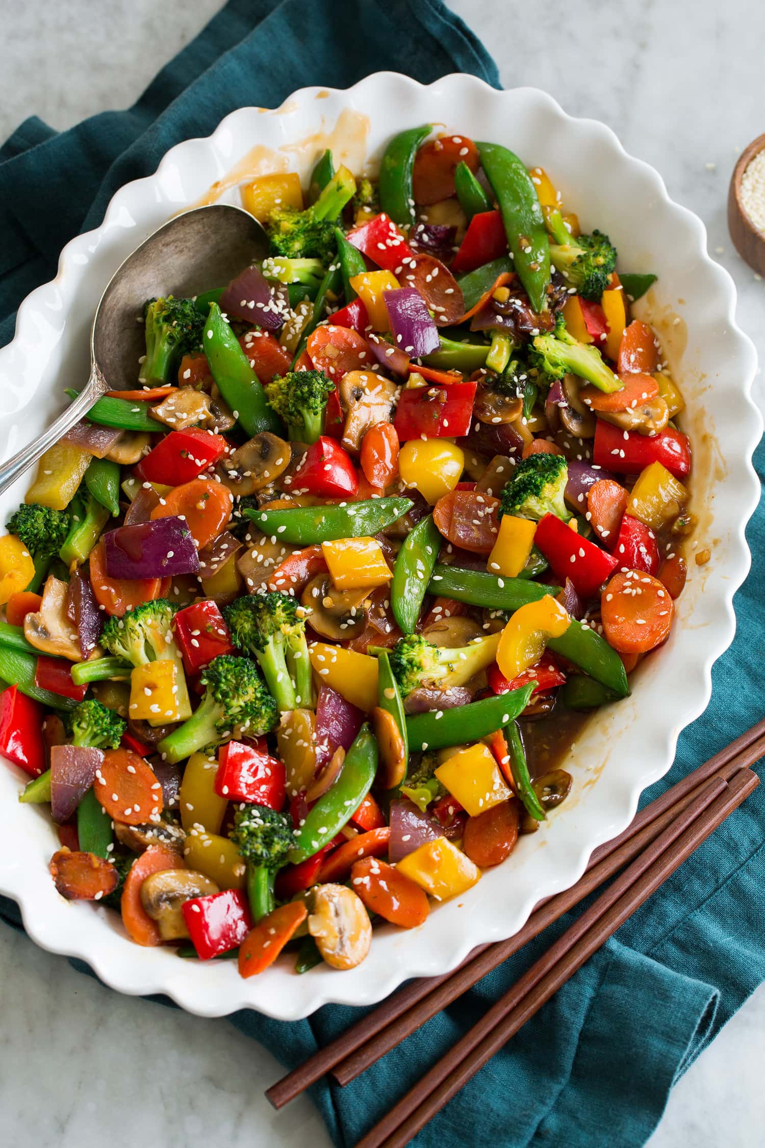 Rainbow stir fried vegetables with sauce in a serving dish.