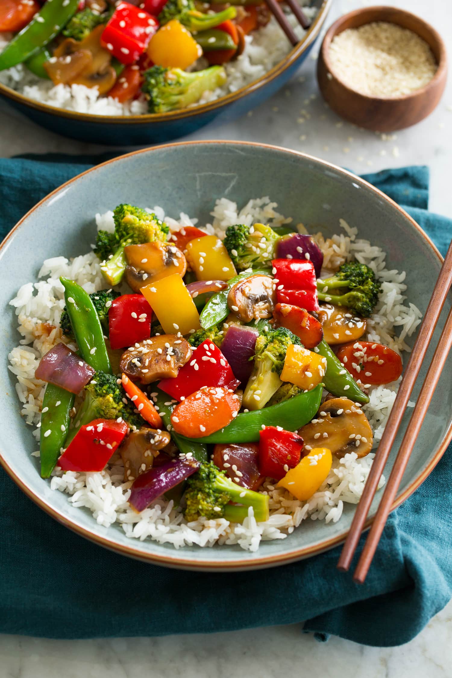 Vegetable stir fry with bell peppers, carrots, peas, broccoli, red onion, and mushrooms.