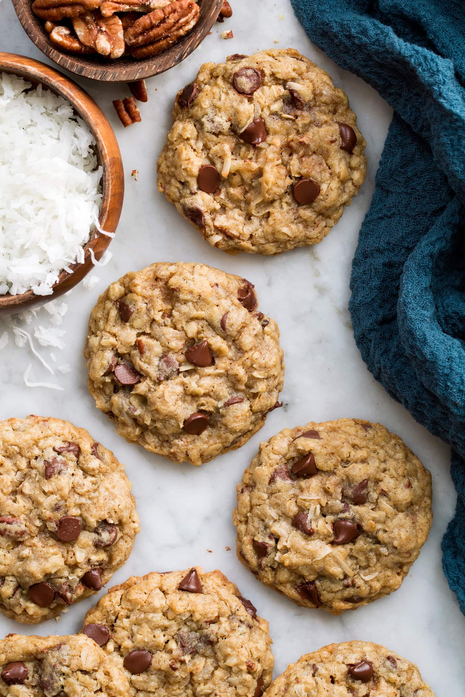 Close up overhead photo of cowboy cookies with coconut and pecans to the side.