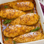 Honey mustard chicken in a baking dish lined up in a row.