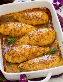 Honey mustard chicken in a baking dish lined up in a row.