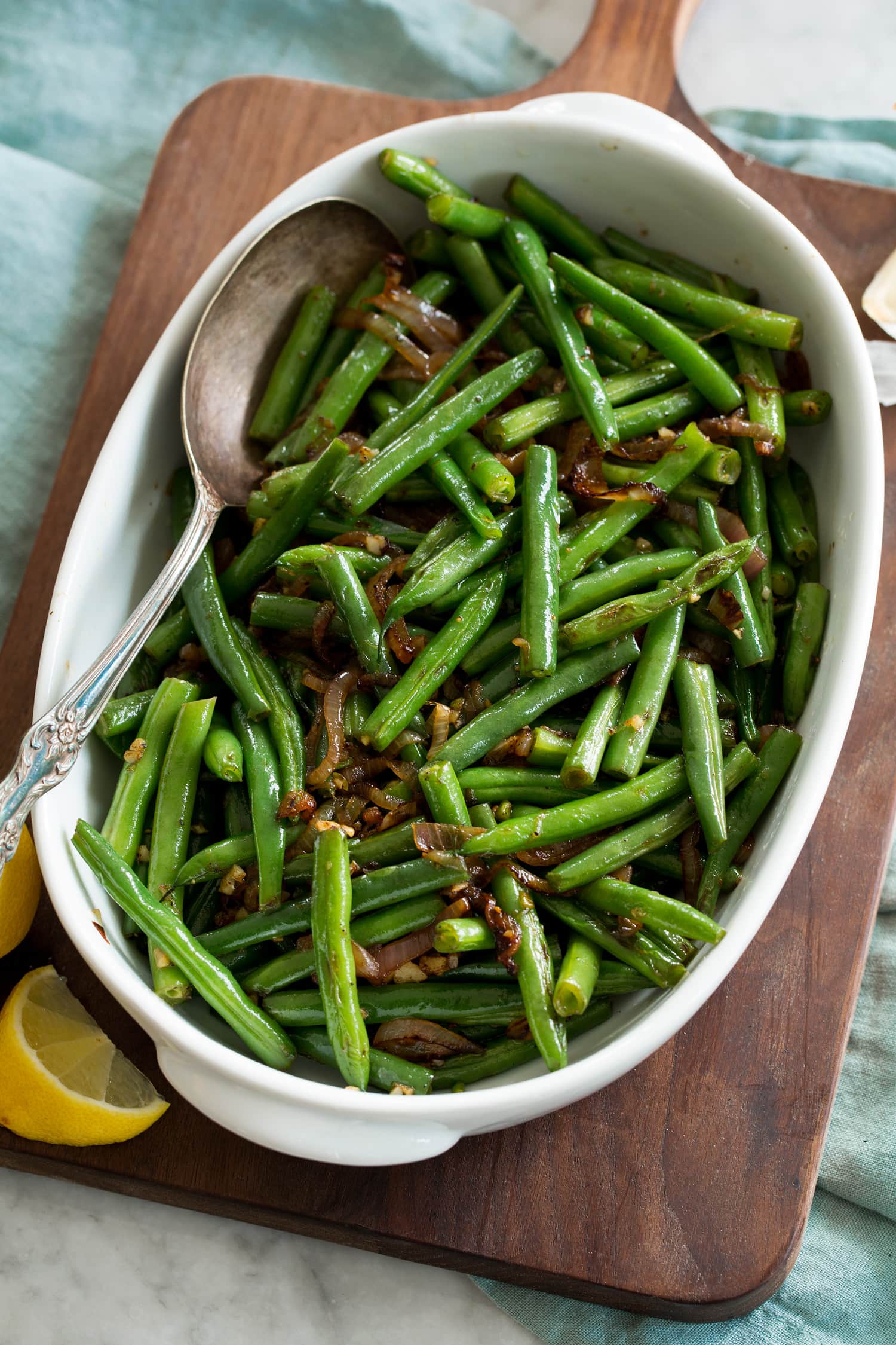 Sauteed fresh green beans shown in a white serving dish.