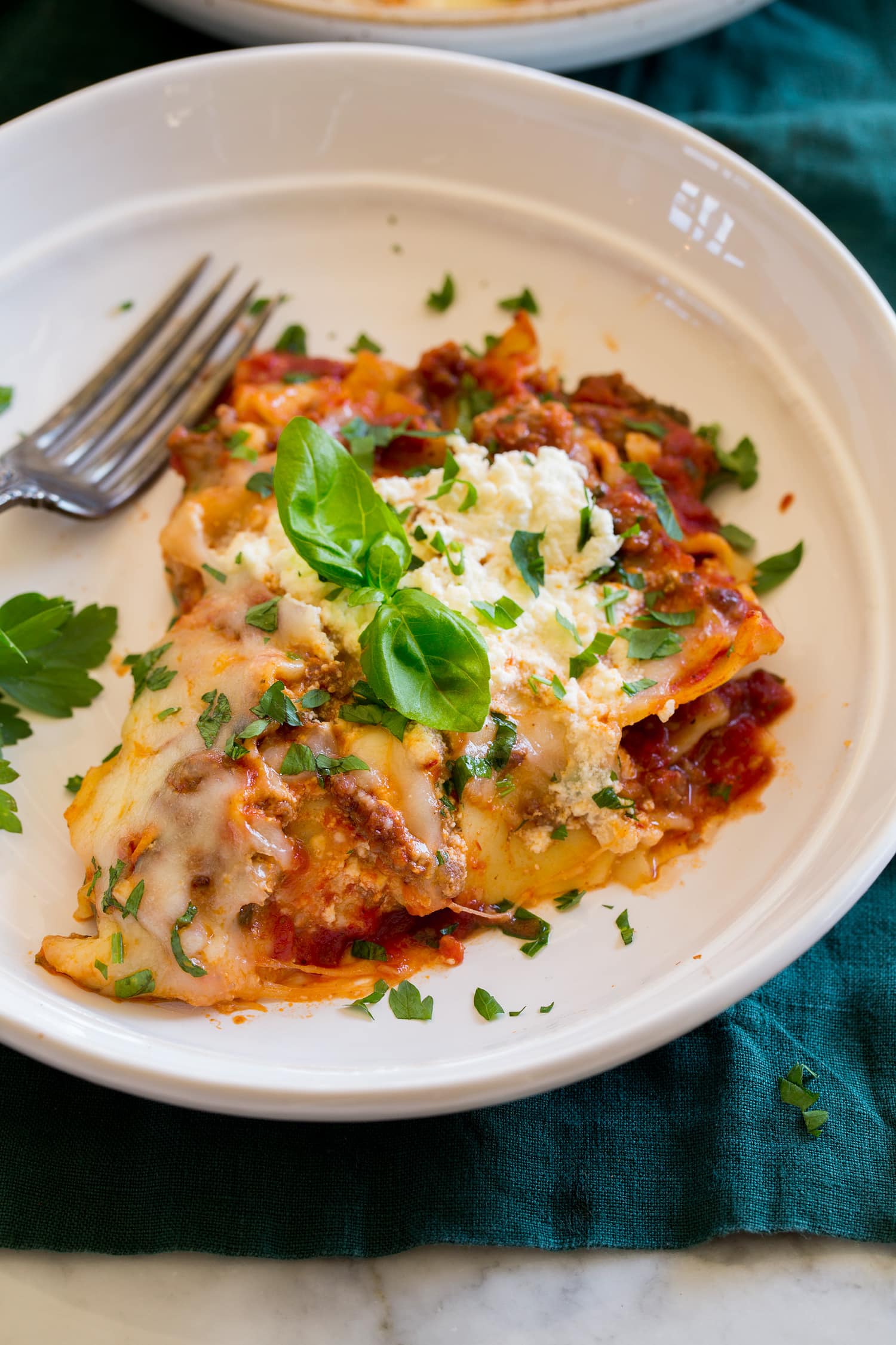 Slice of skillet lasagna in a white pasta bowl.