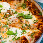 Close up photo of lasagna in large enameled skillet.