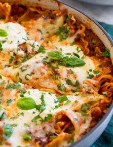 Close up photo of lasagna in large enameled skillet.