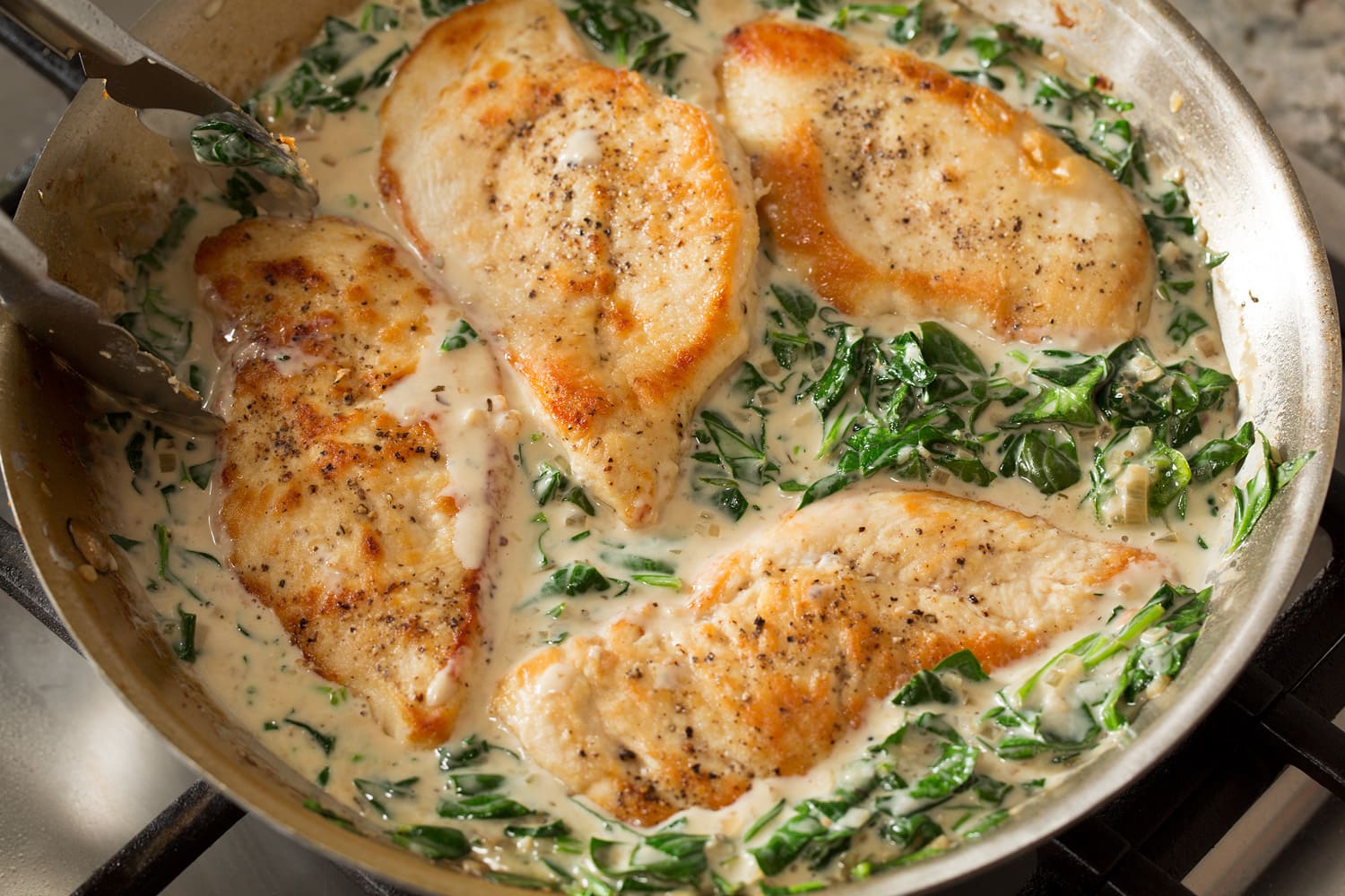 Finished chicken Florentine in skillet.