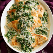 Pan seared chicken breasts with spinach sauce.