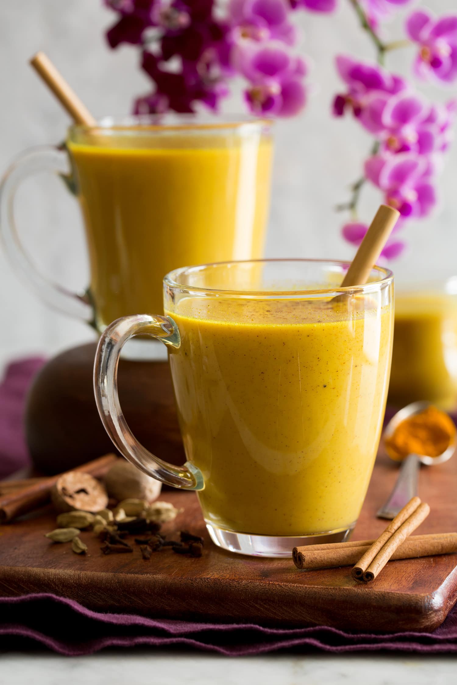 Turmeric milk in clear glass mugs.