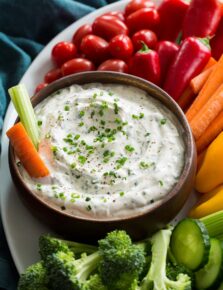 Close up photo of ranch dip in a wooden bowl.