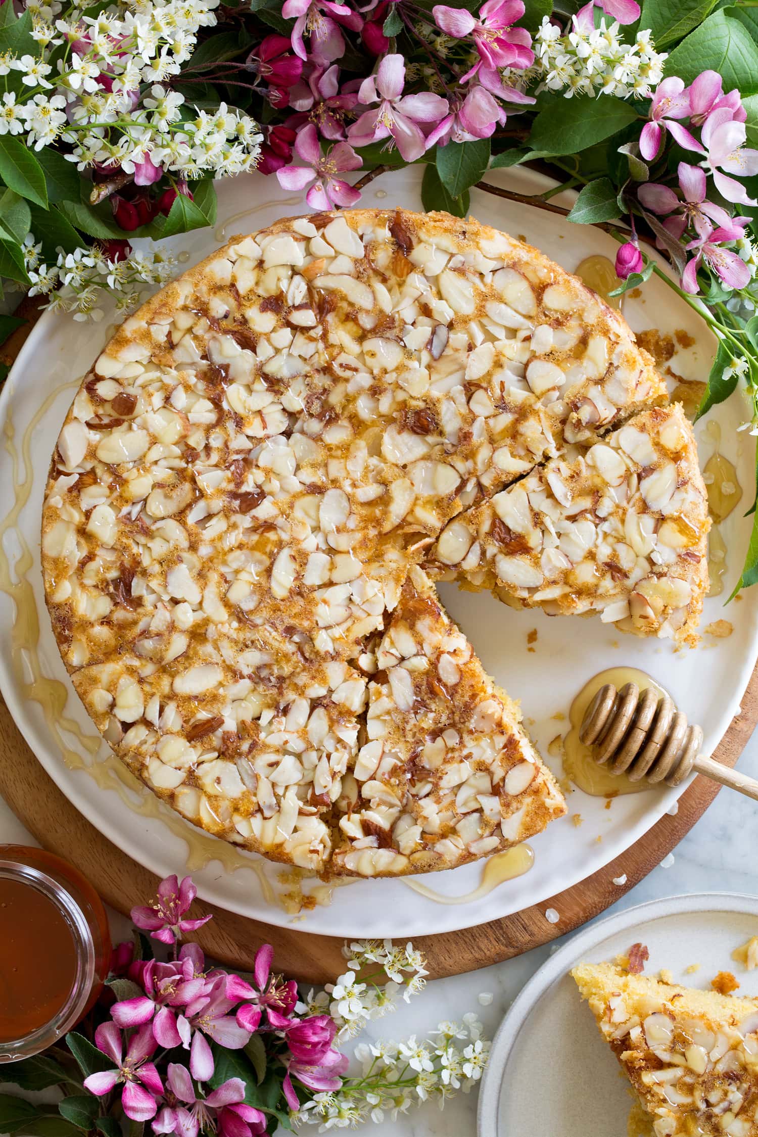 Honey cake surrounded by spring flowers.