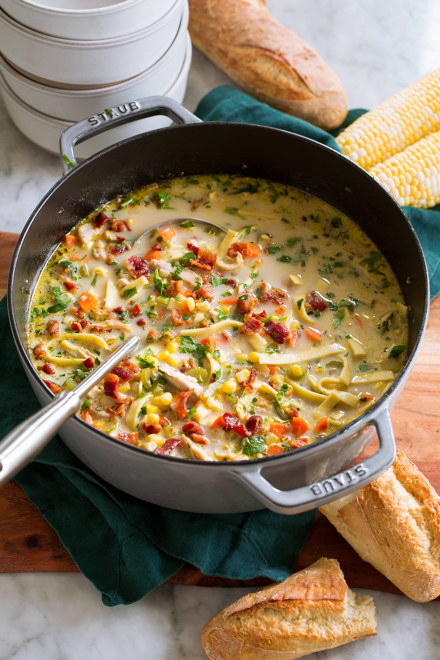 Chicken corn soup in a large grey pot.