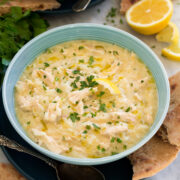 Avgolemono Soup in a turquoise soup bowl.