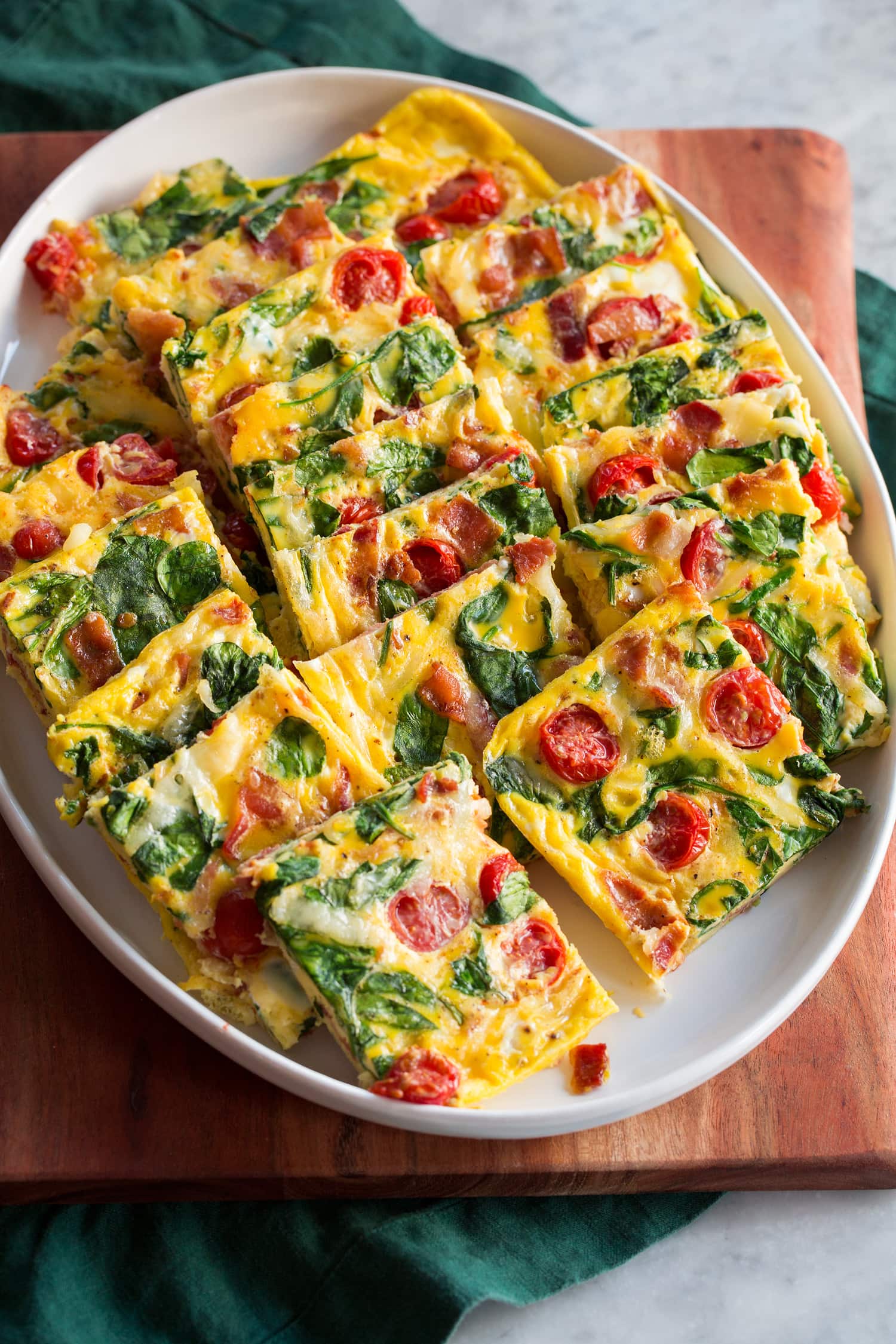 Baked eggs with tomatoes, spinach, swiss, and bacon.