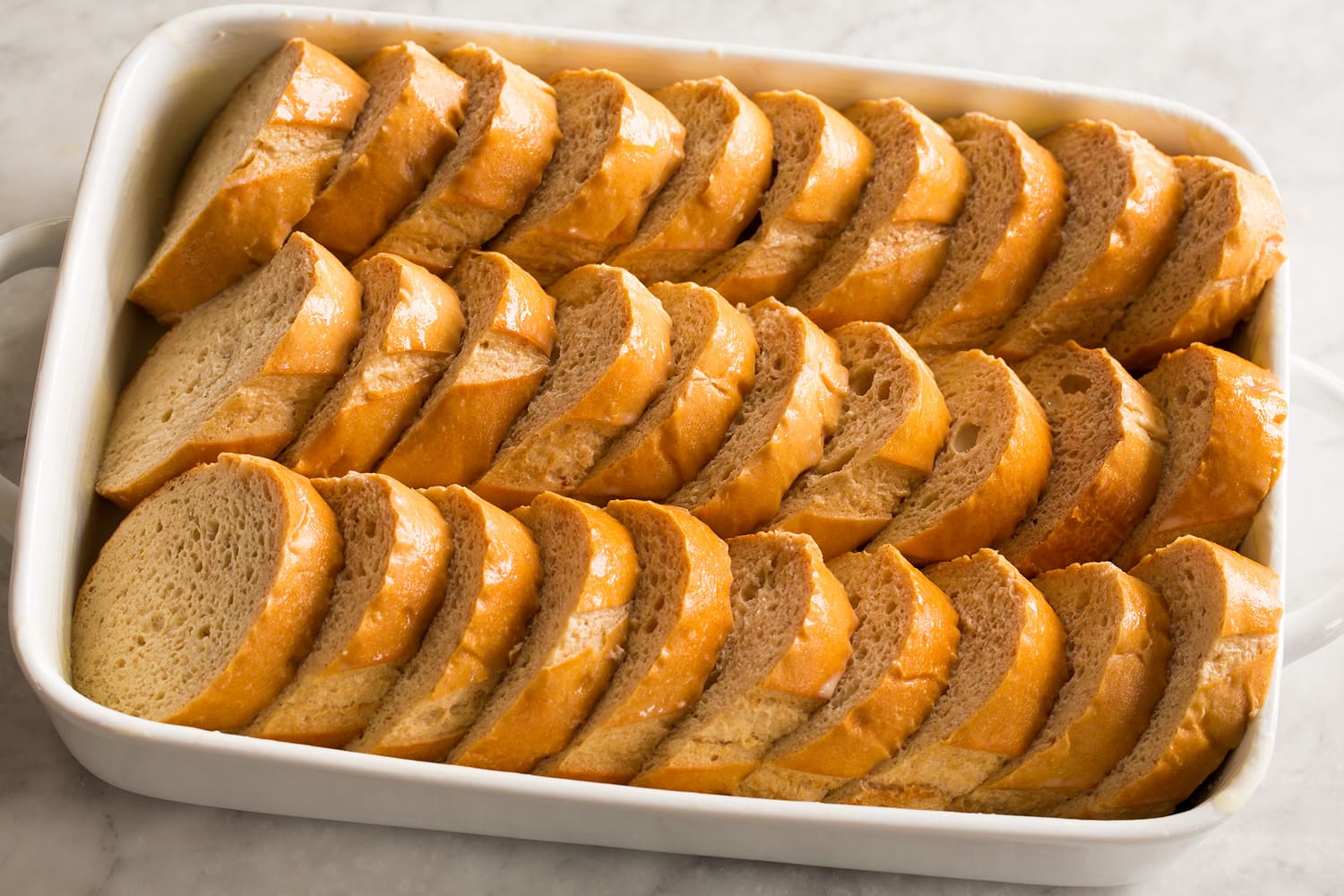 French toast aligned in baking dish.