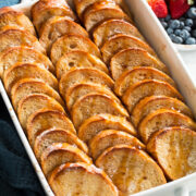 Baked french toast in a white baking dish.