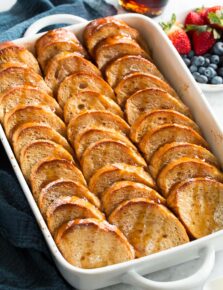 Baked french toast in a white baking dish.