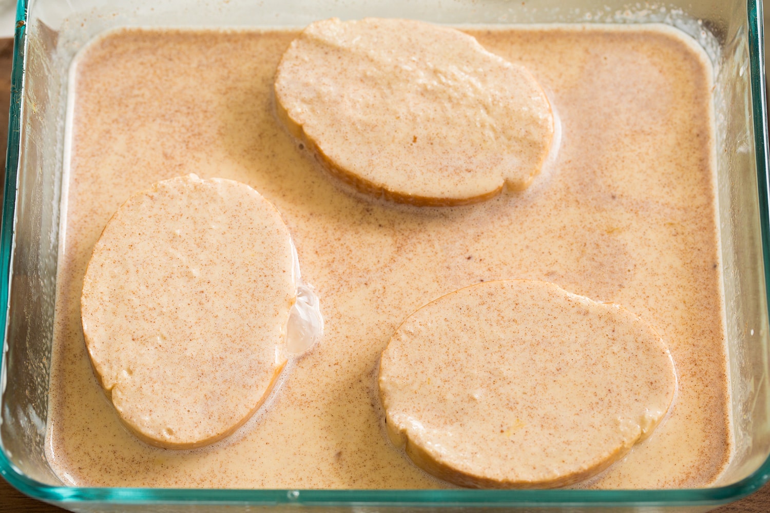 Soaking bread slices in custard mixture.